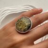Серебряное круглое большое кольцо с темным янтарем с золотыми вкраплениями